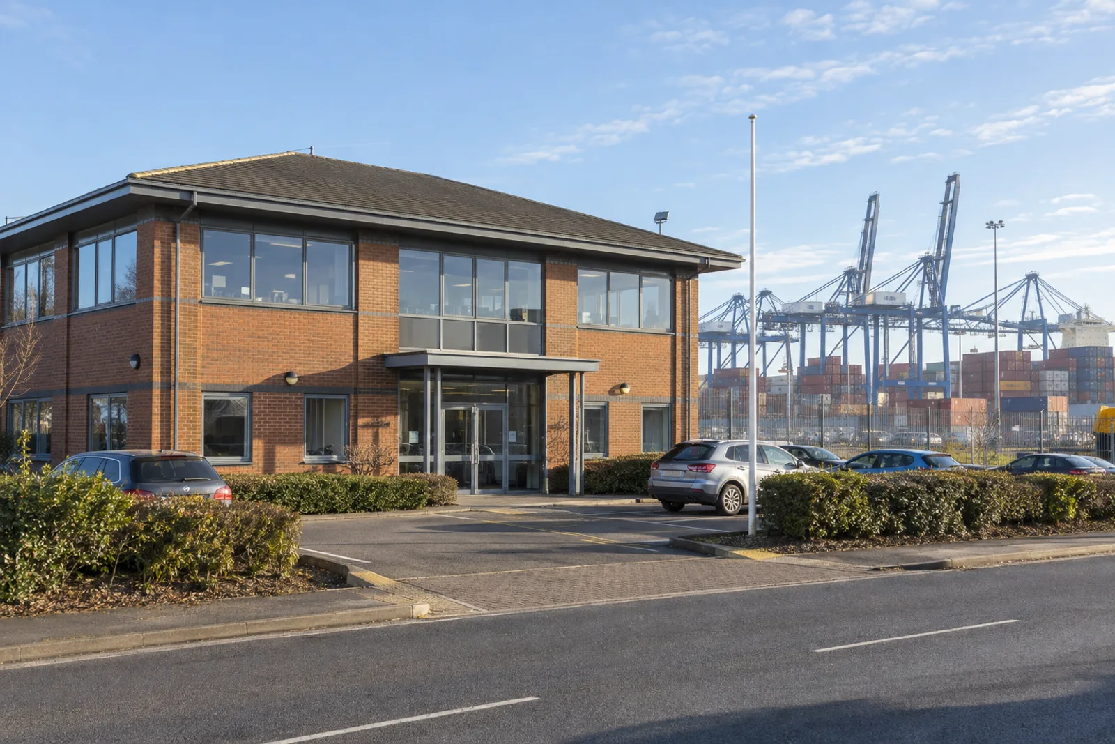 Norholm House on Ferryboat Lane, with the Felixstowe container cranes behind it